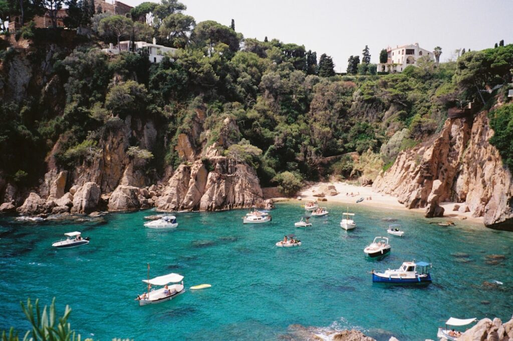 A group of boats floating on top of a body of water
